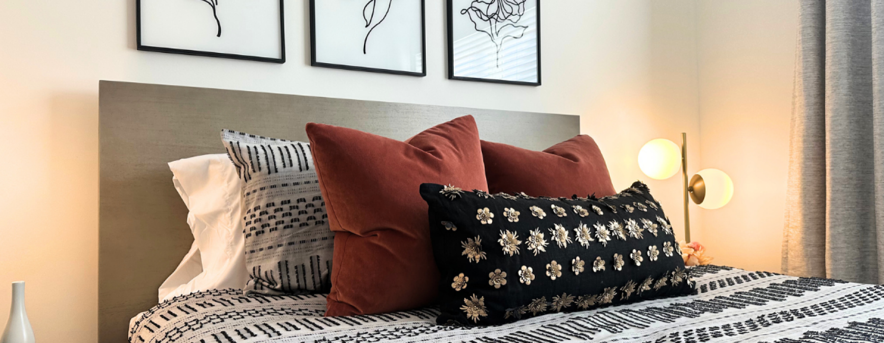 Close up photo of a queen bed with mood lighting