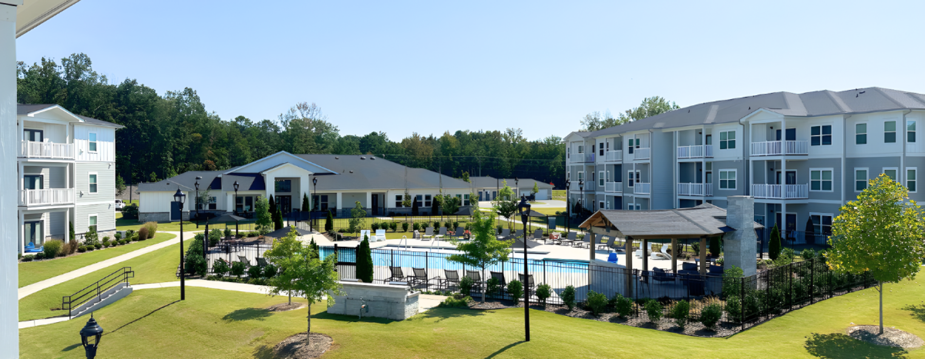 An view of the clubhouse and pool from the balcony at The Caroline apartments in Indian Land SC
